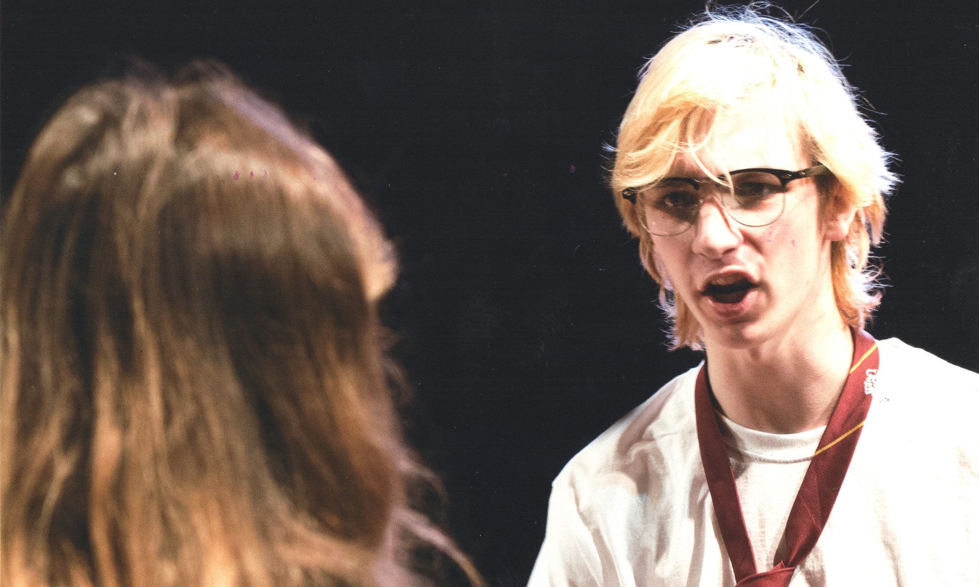 A boy with white-blond hair and glasses