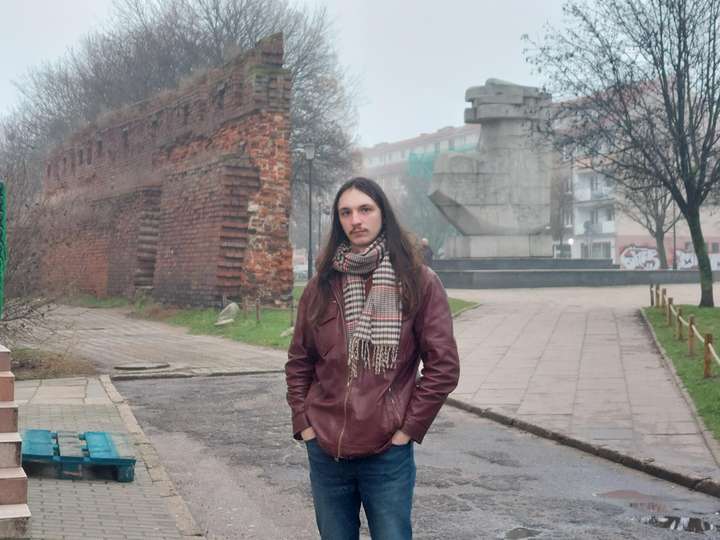 A man standing by the road