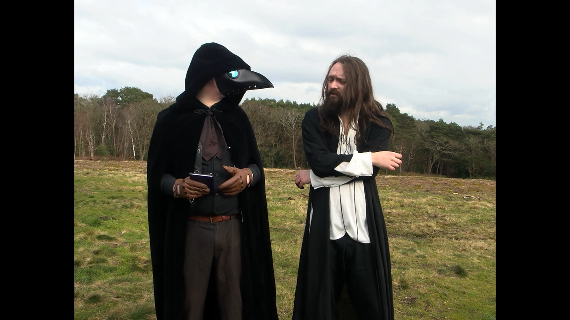 Two actors and two crew filming outdoors