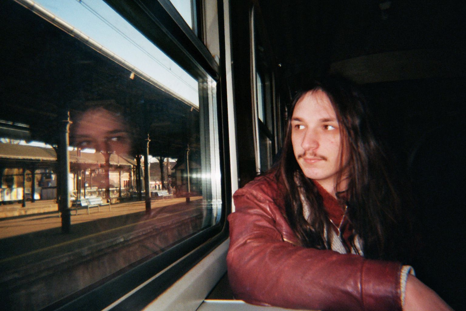 Joseph Rutland on a train with a reflection of himself